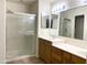 Bathroom featuring a glass-enclosed shower and a double sink vanity with ample storage at 1249 E Commerce Ave, Gilbert, AZ 85234