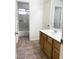 Bathroom featuring a vanity, cabinets, and a shower/tub combo with sliding doors at 1249 E Commerce Ave, Gilbert, AZ 85234