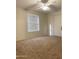 Cozy bedroom with carpet flooring, ceiling fan, and a window at 1249 E Commerce Ave, Gilbert, AZ 85234