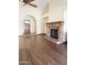 Spacious living room featuring hardwood flooring and a brick fireplace at 1249 E Commerce Ave, Gilbert, AZ 85234