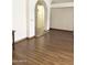 Bright and airy living room with hardwood floors, an archway, and neutral paint at 1249 E Commerce Ave, Gilbert, AZ 85234