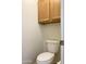 Powder room with toilet and oak cabinet at 1249 E Commerce Ave, Gilbert, AZ 85234