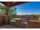 Relaxing outdoor balcony featuring wrought iron chairs and table with views of the surrounding community at 13600 N Fountain Hills Blvd # 501, Fountain Hills, AZ 85268