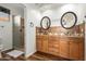 Bathroom with double sink, wood cabinets, decorative tile, and shower with glass partition at 13600 N Fountain Hills Blvd # 501, Fountain Hills, AZ 85268