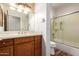 Bathroom features wood cabinets, tile backsplash, and combination bathtub and shower at 13600 N Fountain Hills Blvd # 501, Fountain Hills, AZ 85268