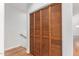 Hall closet with louvered doors on the second floor with hardwood floors and a stairway at 13600 N Fountain Hills Blvd # 501, Fountain Hills, AZ 85268