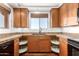 This kitchen showcases updated cabinets, countertops, a sink below a window, and modern appliances at 13600 N Fountain Hills Blvd # 501, Fountain Hills, AZ 85268