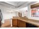 Open kitchen features granite countertops, wood cabinets, and transitions into the dining and living area at 13600 N Fountain Hills Blvd # 501, Fountain Hills, AZ 85268