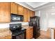 Kitchen featuring warm wood cabinets, stone countertops, and modern appliances at 13600 N Fountain Hills Blvd # 501, Fountain Hills, AZ 85268
