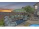 Cozy backyard patio with ample seating around a round table with a colorful umbrella at 16136 W Durango St, Goodyear, AZ 85338