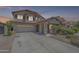 Charming two-story home features a covered porch, two car garage and desert landscaping at 16136 W Durango St, Goodyear, AZ 85338
