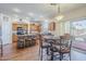 Modern kitchen with island seating, wood cabinets, and sliding doors to outdoor living space at 16136 W Durango St, Goodyear, AZ 85338