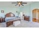 The large main bedroom offers soft carpet and ceiling fan at 16136 W Durango St, Goodyear, AZ 85338
