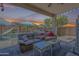 Outdoor patio area with comfortable seating overlooking a private backyard and sparkling pool at 16136 W Durango St, Goodyear, AZ 85338