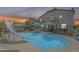 Backyard pool with slide and covered hot tub area, surrounded by well-maintained landscaping at 16136 W Durango St, Goodyear, AZ 85338
