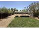 The spacious backyard features a covered garden area with a grassy space for enjoyment at 1813 E Willetta St, Phoenix, AZ 85006