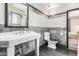 The updated bathroom features stone and white subway tile, a sleek toilet, and a bright mirror at 1813 E Willetta St, Phoenix, AZ 85006