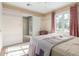 Comfortable bedroom with hardwood floors, a cozy bed, and plenty of natural light at 1813 E Willetta St, Phoenix, AZ 85006