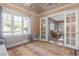 Bright sitting room featuring a decorative tin tile ceiling and adjacent room access through french doors at 1813 E Willetta St, Phoenix, AZ 85006