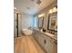 Modern bathroom featuring a soaking tub, dual sinks, and a glass-enclosed shower at 18747 W Monterosa St, Litchfield Park, AZ 85340