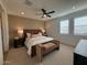 Serene bedroom with a comfortable bed, ceiling fan, plantation shutters, and neutral decor for a relaxing atmosphere at 18747 W Monterosa St, Litchfield Park, AZ 85340
