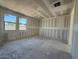 This unfinished bedroom shows large windows and potential for customization at 18747 W Monterosa St, Litchfield Park, AZ 85340