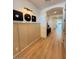 Modern home hallway with decorative wall trim, wood floors, and an arched doorway leading to bright living spaces at 18747 W Monterosa St, Litchfield Park, AZ 85340