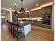 Well-appointed kitchen featuring a large island, stainless steel appliances, and ample cabinet space for storage at 18747 W Monterosa St, Litchfield Park, AZ 85340
