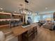 Open-concept living space with dining area, modern lighting, comfortable seating, and access to an outdoor patio at 18747 W Monterosa St, Litchfield Park, AZ 85340