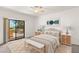 Cozy bedroom featuring a plush bed, decorative rug, side tables with lamps, and a balcony access door at 19400 N Westbrook Pkwy # 220, Peoria, AZ 85382
