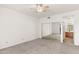 Spacious bedroom with neutral carpet, a ceiling fan, and access to the ensuite bathroom at 19400 N Westbrook Pkwy # 220, Peoria, AZ 85382