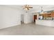 Bright and airy living room flowing into an open kitchen, featuring neutral tones and a ceiling fan at 19400 N Westbrook Pkwy # 220, Peoria, AZ 85382