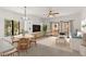 Bright living room with dining area, neutral decor, ceiling fan, balcony access and lots of natural light at 19400 N Westbrook Pkwy # 220, Peoria, AZ 85382