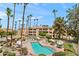 A refreshing community pool featuring comfortable lounge chairs, umbrellas, and lush landscaping at 19400 N Westbrook Pkwy # 220, Peoria, AZ 85382