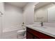 Bathroom featuring a vanity with a dark wood cabinet, a toilet, and a tiled shower-tub combo at 2000 N 36Th St # 10, Phoenix, AZ 85008