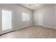 Bedroom with neutral paint and tile flooring, bright natural light, and two doors at 2000 N 36Th St # 10, Phoenix, AZ 85008