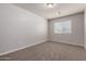 Bedroom with plush carpet, neutral walls, and a window with blinds providing natural light at 2000 N 36Th St # 10, Phoenix, AZ 85008
