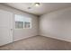 Carpeted bedroom with a window and blinds, offering a comfortable and private space at 2000 N 36Th St # 10, Phoenix, AZ 85008