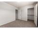 Bedroom featuring carpet flooring and multiple doors, offering access to different areas of the home at 2000 N 36Th St # 10, Phoenix, AZ 85008