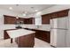Modern kitchen with stainless steel appliances, brown cabinets, and a large island at 2000 N 36Th St # 10, Phoenix, AZ 85008
