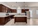 Modern kitchen with stainless appliances, dark wood cabinets, and a center island at 2000 N 36Th St # 10, Phoenix, AZ 85008