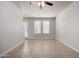 Bright living room with tile floors, fan, and multiple windows for natural light at 2000 N 36Th St # 10, Phoenix, AZ 85008