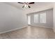 Open-concept living room with tile floors, fan, and multiple windows for natural light at 2000 N 36Th St # 10, Phoenix, AZ 85008