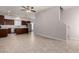 Open-concept living room and kitchen with tile floors, stainless appliances, and brown cabinets at 2000 N 36Th St # 10, Phoenix, AZ 85008