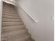 Carpeted staircase with a handrail and a light switch, leading to the upper level at 2000 N 36Th St # 10, Phoenix, AZ 85008
