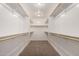 Spacious walk-in closet featuring carpet flooring and multiple shelves with wooden rods at 2000 N 36Th St # 10, Phoenix, AZ 85008