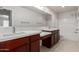 Double vanity bathroom with wood cabinets, quartz countertops, and tiled floors at 2000 N 36Th St # 41, Phoenix, AZ 85008