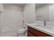 This bathroom features a shower-tub combo with white tiling and cherry wood vanity at 2000 N 36Th St # 41, Phoenix, AZ 85008
