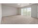This bedroom features carpet, neutral paint, and a sliding glass door leading to a balcony at 2000 N 36Th St # 41, Phoenix, AZ 85008