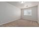 This bedroom features neutral paint, carpet, and a window with blinds at 2000 N 36Th St # 41, Phoenix, AZ 85008